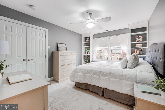 bedroom featuring visible vents, baseboards, ceiling fan, carpet floors, and a closet