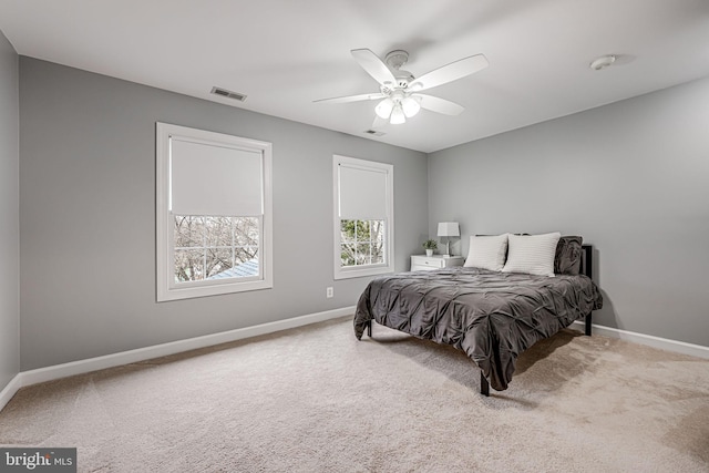 carpeted bedroom featuring visible vents, baseboards, and ceiling fan