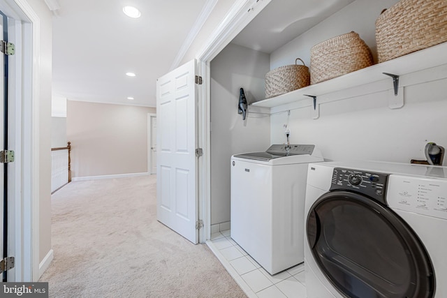 washroom featuring light colored carpet, laundry area, and washer and clothes dryer