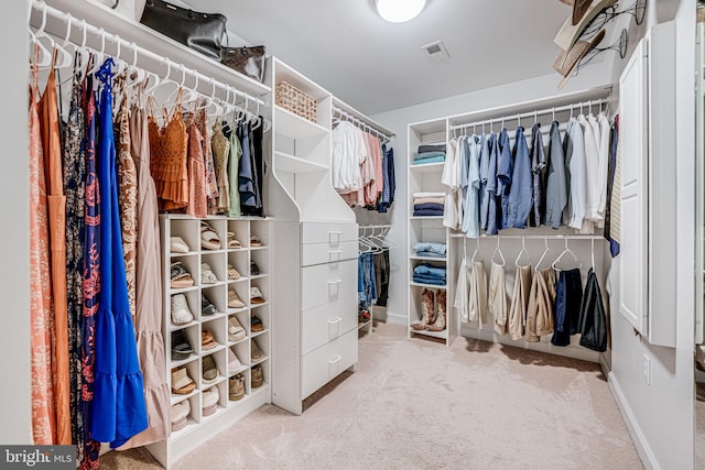 walk in closet with visible vents and carpet