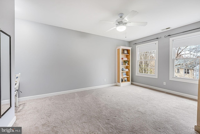 unfurnished room featuring visible vents, ceiling fan, baseboards, and carpet floors