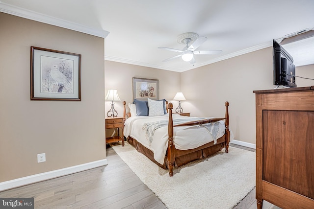 bedroom with wood finished floors, a ceiling fan, baseboards, and ornamental molding