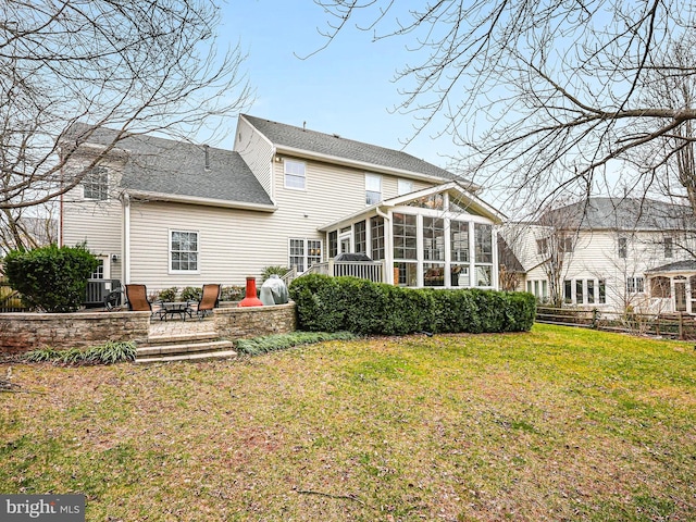 back of property featuring a patio area, fence, a yard, and a sunroom