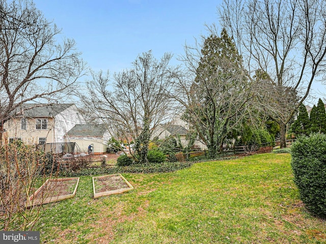 view of yard with a garden and fence