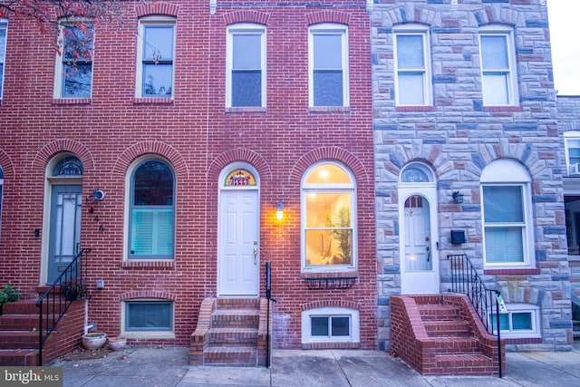 townhome / multi-family property with brick siding and entry steps