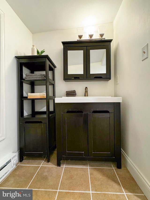 bathroom featuring tile patterned floors, vanity, a baseboard heating unit, and baseboards