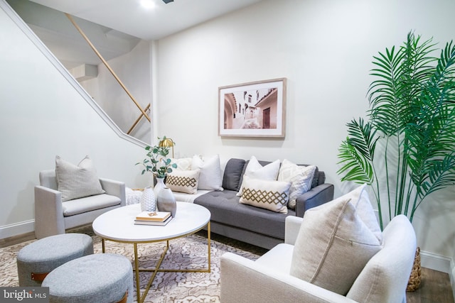 living area with baseboards and wood finished floors