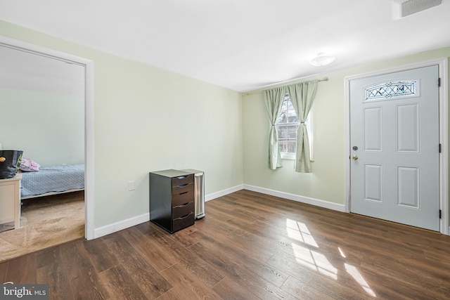 entrance foyer featuring visible vents, baseboards, and dark wood finished floors