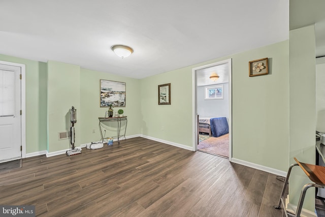 interior space featuring wood finished floors, visible vents, and baseboards