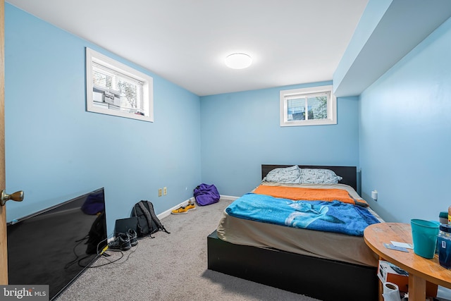 carpeted bedroom featuring baseboards