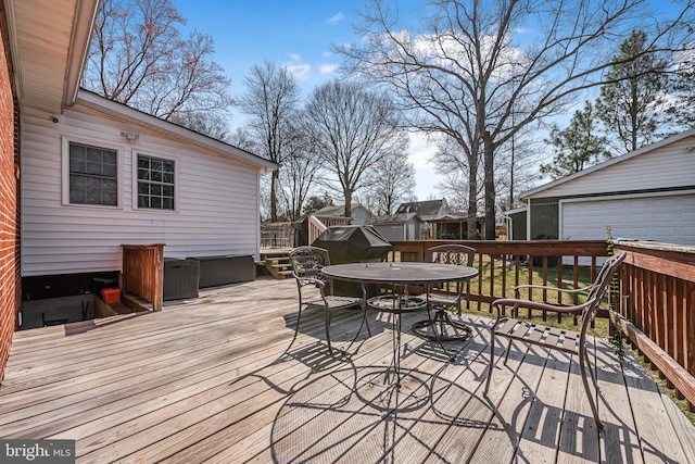 deck featuring outdoor dining area and an outdoor structure