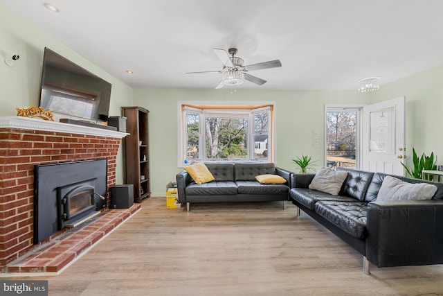 living room with recessed lighting, light wood-type flooring, and a ceiling fan