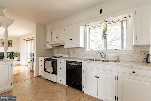 kitchen featuring a sink, under cabinet range hood, range with gas stovetop, black dishwasher, and light tile patterned flooring