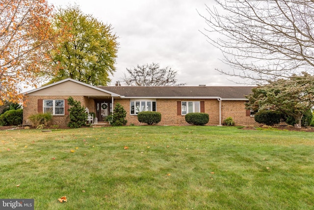 ranch-style house with brick siding and a front lawn