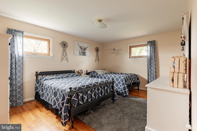 bedroom featuring light wood-type flooring and baseboards