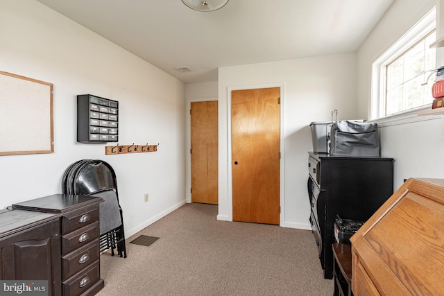 office space with visible vents, baseboards, and carpet