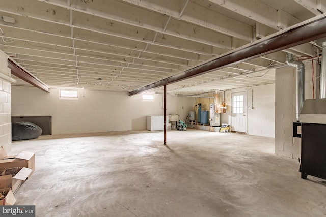 below grade area with a sink, plenty of natural light, and washer / dryer