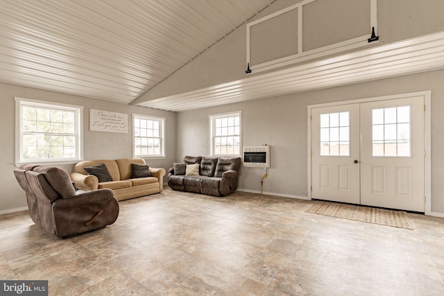 living area with french doors, baseboards, high vaulted ceiling, and heating unit