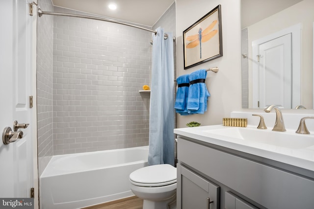 full bath featuring shower / bath combination with curtain, toilet, and vanity