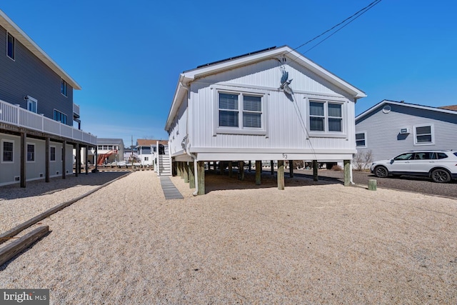 exterior space featuring a carport, stairway, and driveway