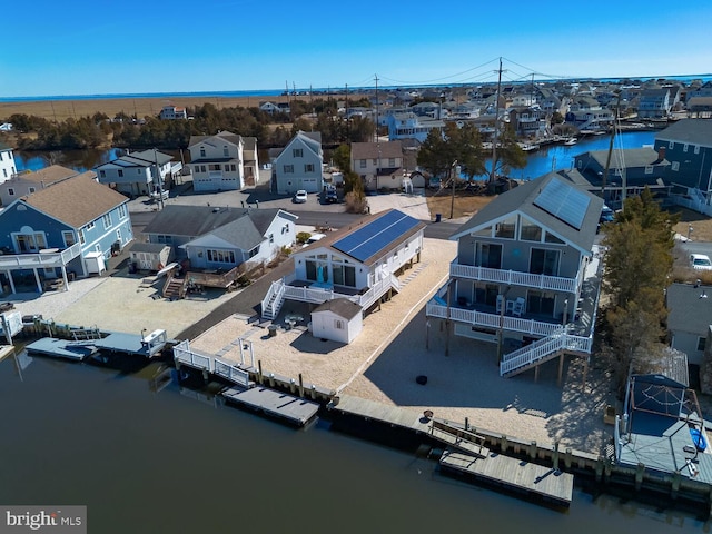 birds eye view of property featuring a water view and a residential view