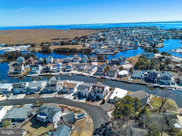 drone / aerial view featuring a residential view and a water view