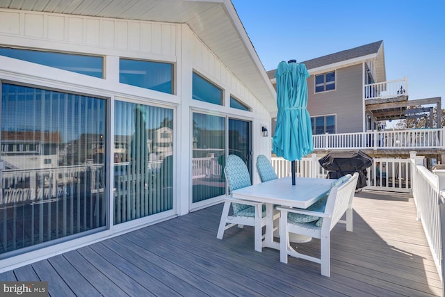 wooden deck featuring area for grilling and outdoor dining space