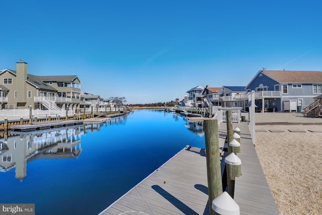 dock area with a residential view and a water view