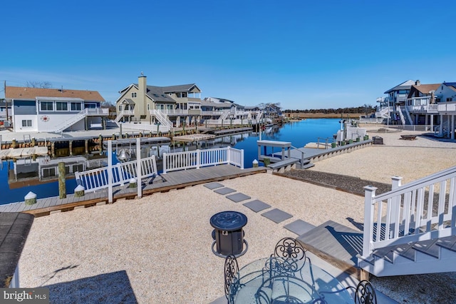 view of dock featuring a residential view and a water view