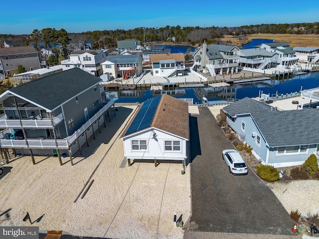 drone / aerial view with a residential view and a water view