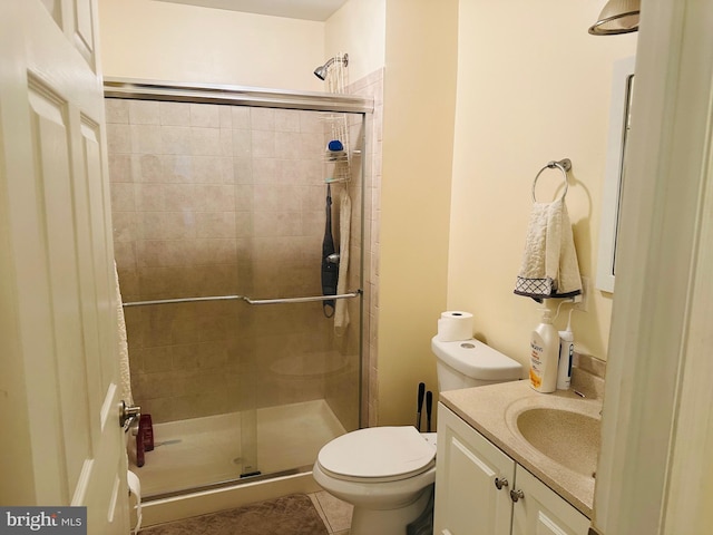 full bath with tile patterned flooring, a shower stall, toilet, and vanity