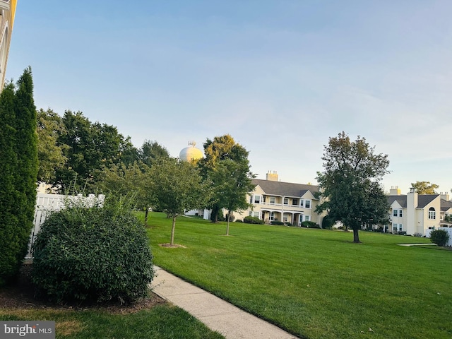 view of home's community featuring a lawn