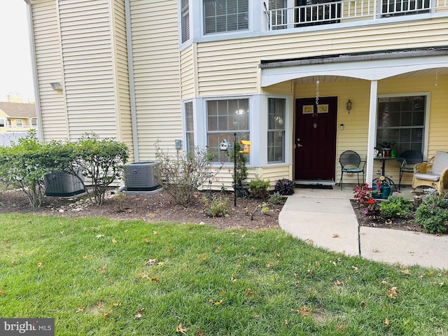 entrance to property with a balcony and central AC