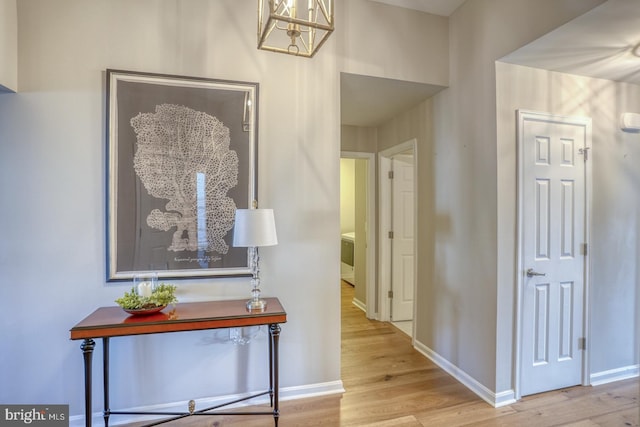 hallway featuring wood finished floors and baseboards