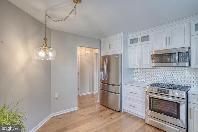 kitchen featuring white cabinets, stainless steel appliances, and light countertops