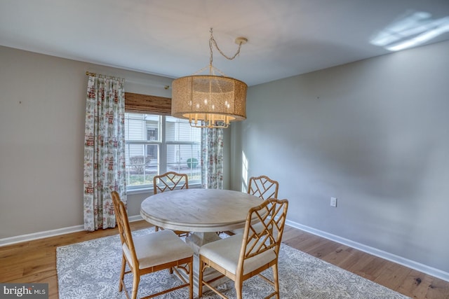 dining area with wood finished floors and baseboards