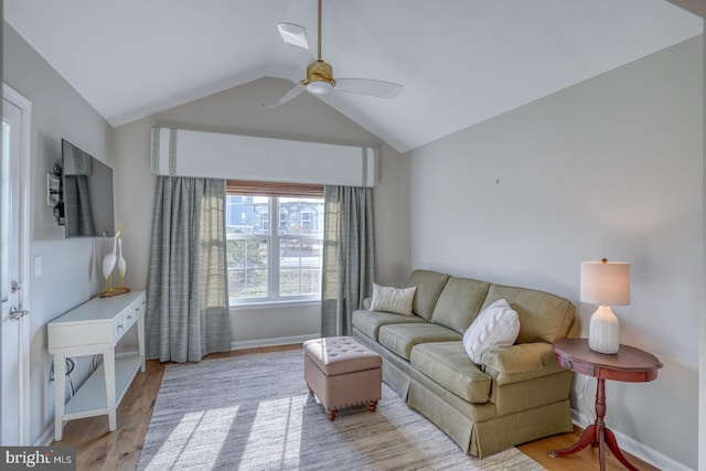 living room with vaulted ceiling, baseboards, a ceiling fan, and wood finished floors