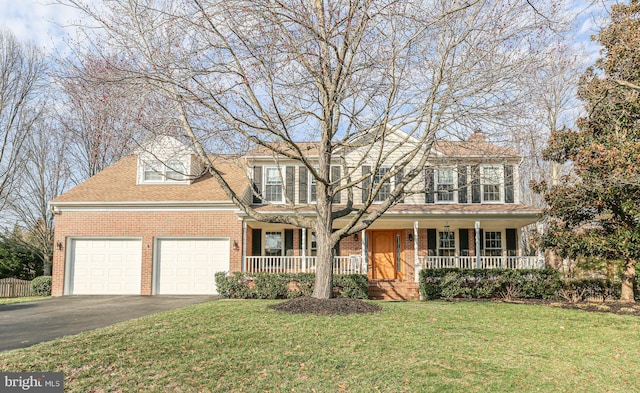 view of front of property with a porch, an attached garage, brick siding, and aphalt driveway