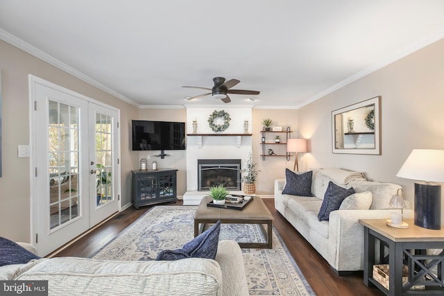 living room featuring french doors, dark wood finished floors, a ceiling fan, and crown molding