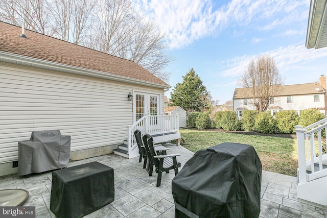 view of patio with a storage shed, an outdoor structure, area for grilling, and french doors