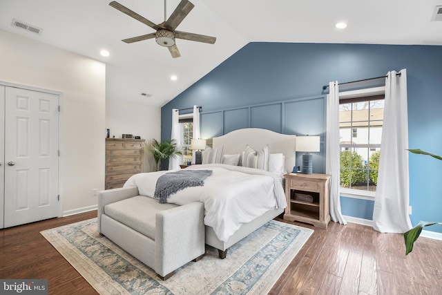 bedroom with visible vents, lofted ceiling, and wood finished floors