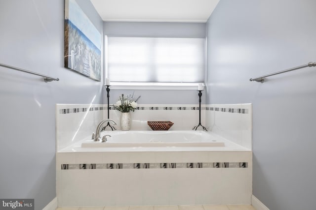 bathroom with tile patterned floors, baseboards, and a garden tub