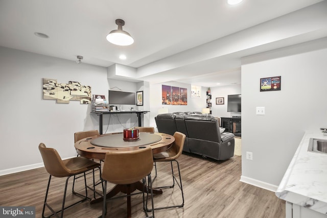 dining room with recessed lighting, wood finished floors, and baseboards