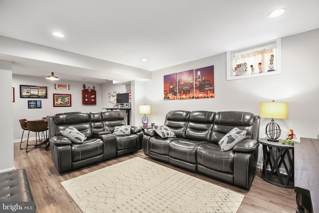 living room with recessed lighting, baseboards, and wood finished floors