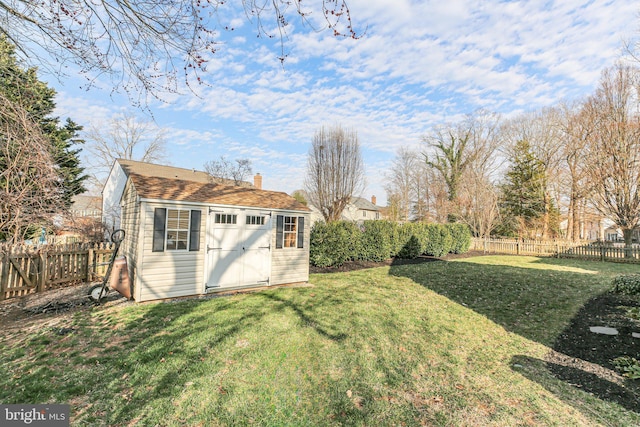 view of yard with a storage unit, an outbuilding, and a fenced backyard