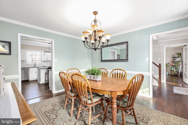 dining area with dark wood-style floors, a chandelier, and ornamental molding