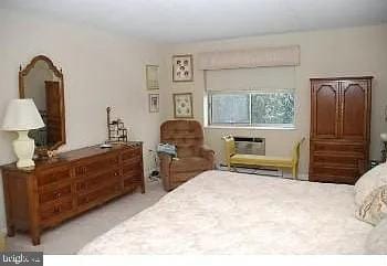 bedroom featuring a wall mounted air conditioner