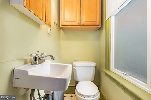 bathroom featuring toilet and a sink