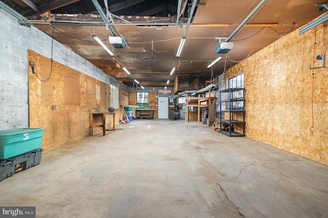 garage with a workshop area and a garage door opener