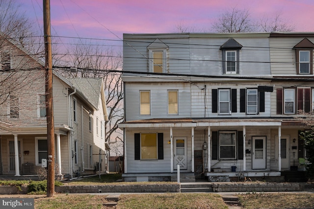 view of property featuring covered porch